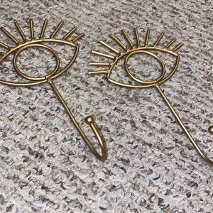 Brass, eye shaped, wall hooks. New condition.